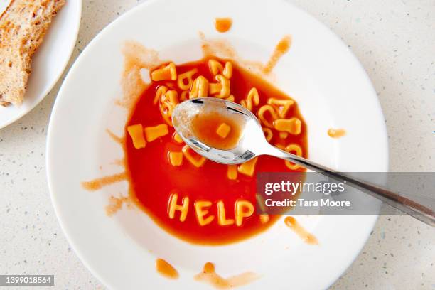 the word help written with alphabet spaghetti - alphabet food stock pictures, royalty-free photos & images