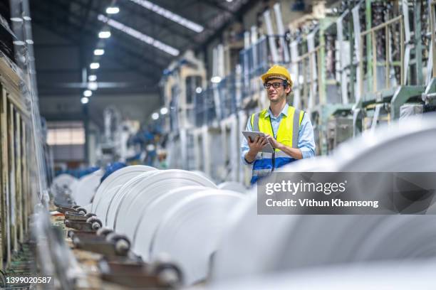 manufacturers engineer and tablet working at plastic bag manufacturers. - industria foto e immagini stock