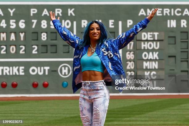 Six time WWE Women's Champion Sasha Banks holds up her arms after throwing out the first pitch before the game between the Boston Red Sox and the...