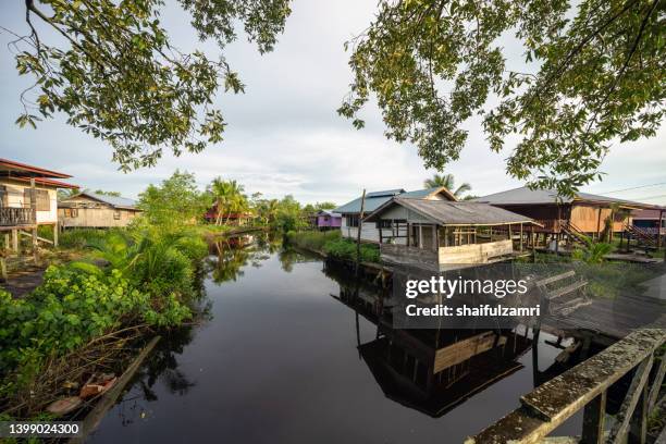 view of traditional wooden house near river at sarawak, malaysia - sarawak state stock pictures, royalty-free photos & images
