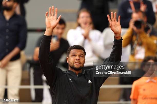 Jo-Wilfried Tsonga of France waves goodbye to the crowd after losing his match against Casper Ruud of Norway, his last match at Roland Garros during...