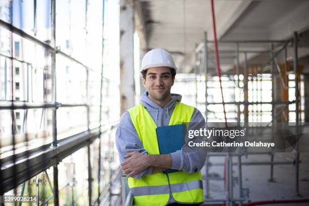 portrait of male architect holding digital tablet while examining construction site - confident young man at work stock pictures, royalty-free photos & images