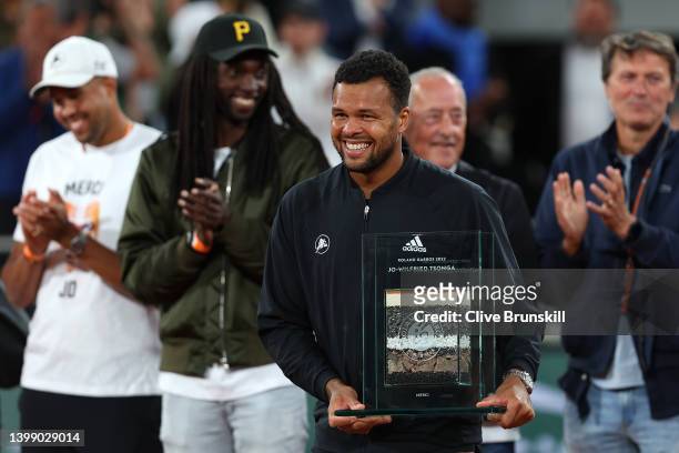 Jo-Wilfried Tsonga of France poses during a presentation ceremony after his last match at Roland Garros during the Men's Singles First Round on Day 3...