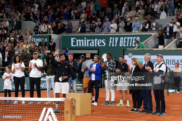 Jo-Wilfried Tsonga of France waves to the crowd during a presentation ceremony after his last match at Roland Garros during the Men's Singles First...