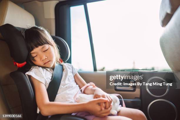 lovely little girl taking nap in her car seat while riding in car - kid car safety stock pictures, royalty-free photos & images