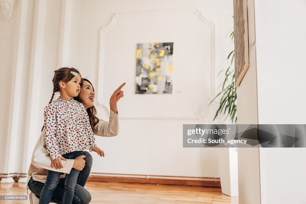 Mother and daughter in art gallery