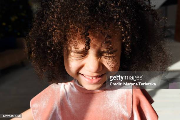 portrait of a little beautiful afro girl. children's smile. curly curly hair. a cute baby. - portraits studio smile foto e immagini stock