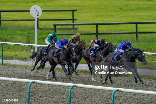 Adam Kirby riding Watchya win The Russell Publishing 30th Anniversary Handicap at Lingfield Park on May 24, 2022 in Lingfield, England.