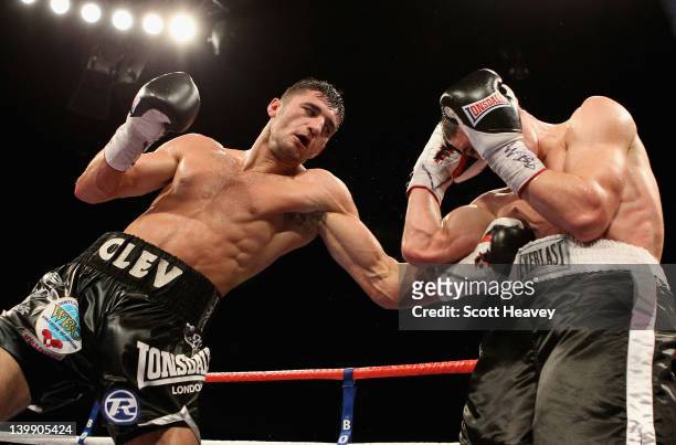 Nathan Cleverly in action with Tommy Karpency during the WBO Light-Heavyweight Championship bout at the Motorpoint Arena on February 25, 2012 in...