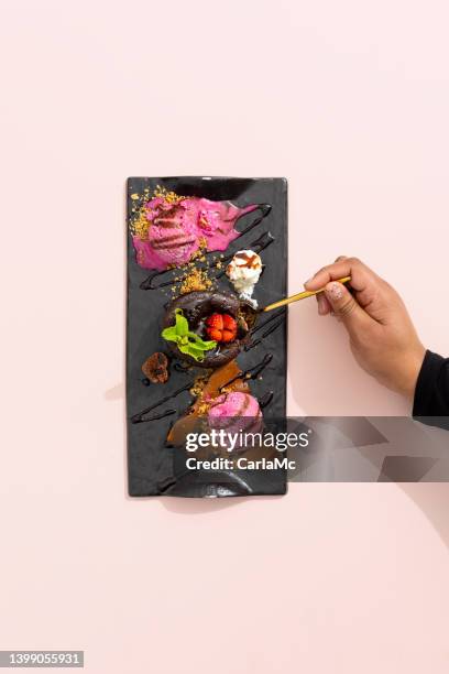 hand reaching for chocolate fondant dessert - vierkant bord stockfoto's en -beelden