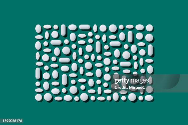 a variety of white pills arranged in a rectangle shape - generic drug stock pictures, royalty-free photos & images