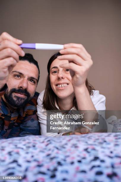 couple waiting for the result of the pregnancy test. - woman smiling facing down stock pictures, royalty-free photos & images