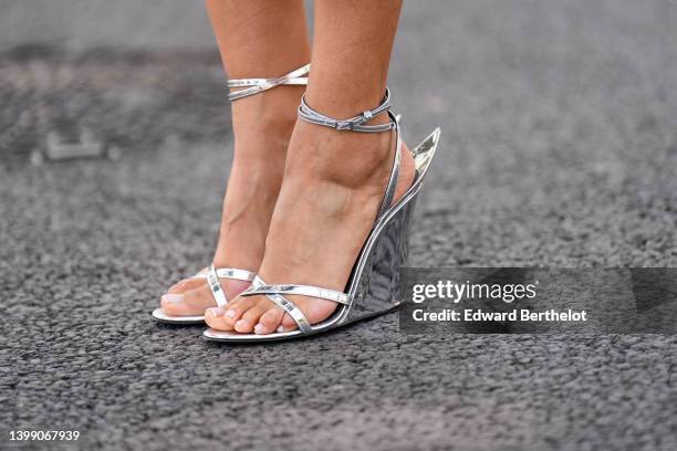 Patricia Gloria Contreras wears silver high heels platform shoes on May 24, 2022 in Cannes, France.