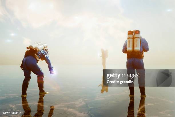 men in hazmat suits picking up paranormal objects - alien planet space stock pictures, royalty-free photos & images