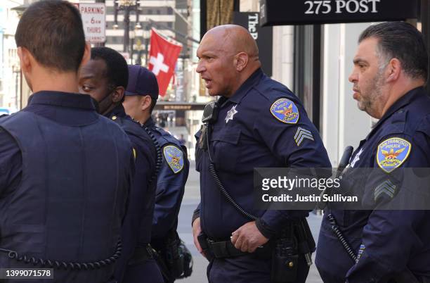San Francisco police officers look on as they assist San Francisco firefighters during a medical call on May 24, 2022 in San Francisco, California....