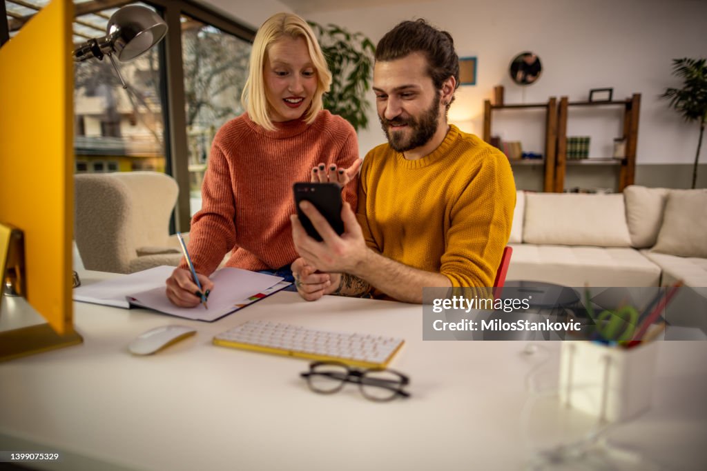 Couple Using One Computer Shot Of A Young Couple Using A Computer Together At Home High-Res Stock ...