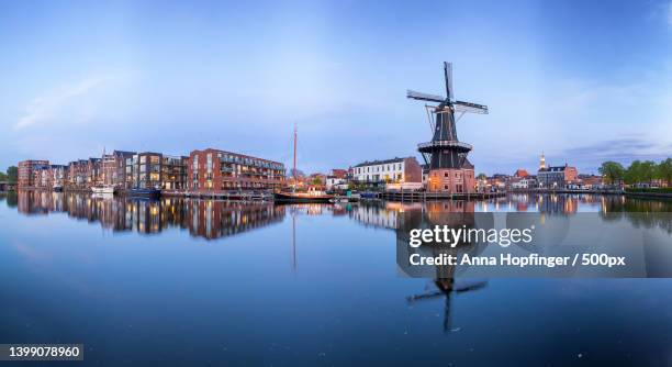 windmill de adriaan in haarlem during the blue hour,haarlem,netherlands - haarlem stock pictures, royalty-free photos & images