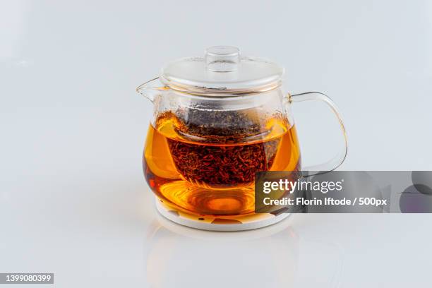 close-up of drink in glass against white background - théière photos et images de collection