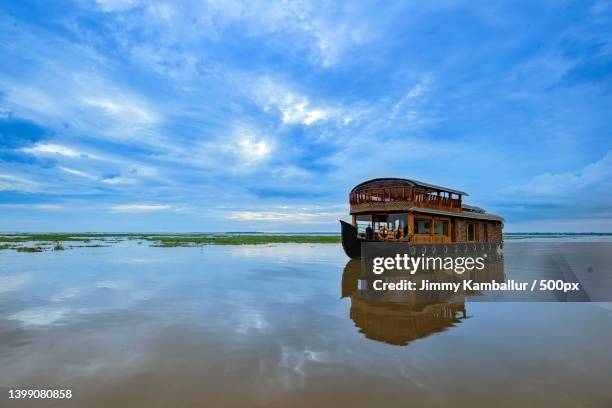 scenic view of lake against sky,kumarakom,kerala,india - backwater stock pictures, royalty-free photos & images