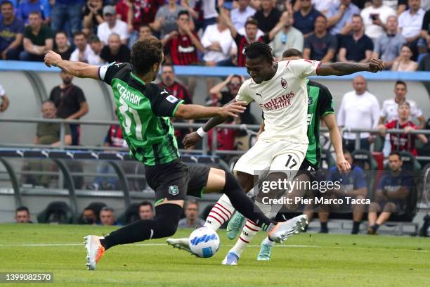 Gian Marco Ferrari of US Sassuolo competes for the ball with Rafael Leao of AC Milan during the Serie A match between US Sassuolo and AC Milan at...