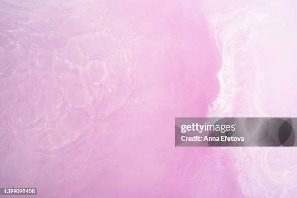 soapy purple water with foam from bath bomb and light reflections. backdrop with copy space for your design - bath bomb stock pictures, royalty-free photos & images