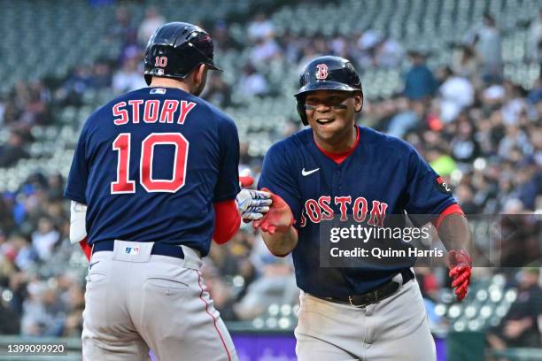 Trevor Story and Rafael Devers of the Boston Red Sox celebrate the three run home run in the first inning against the Chicago White Sox at Guaranteed...