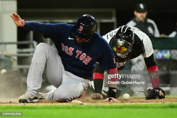 Martinez of the Boston Red Sox slides in to beat the tag by Yasmani Grandal of the Chicago White Sox to score in the fourth inning at Guaranteed Rate...