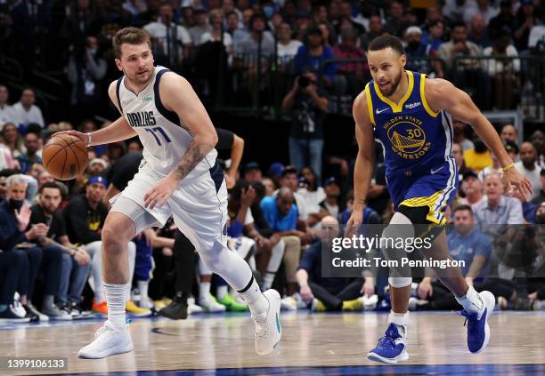 Luka Doncic of the Dallas Mavericks brings the ball up court against Stephen Curry of the Golden State Warriors during the second quarter in Game...