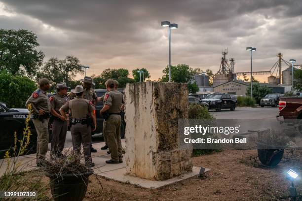 Law enforcement officers speak together outside of the SSGT Willie de Leon Civic Center following the mass shooting at Robb Elementary School on May...