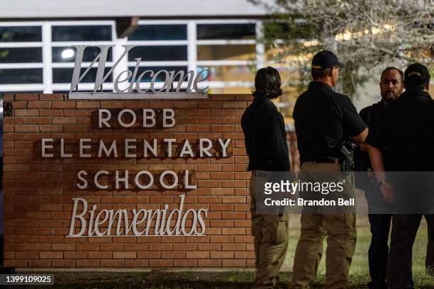 Law enforcement officers speak together outside of Robb Elementary School following the mass shooting at Robb Elementary School on May 24, 2022 in...