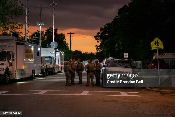 Law enforcement officers speak together outside of Robb Elementary School following the mass shooting at Robb Elementary School on May 24, 2022 in...