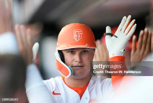 Joc Pederson of the San Francisco Giants is congratulated by teammates after he hit a two-run home run against the New York Mets in the bottom of the...