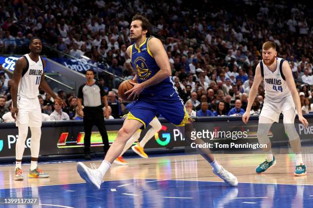 Nemanja Bjelica of the Golden State Warriors drives to the basket against Dorian Finney-Smith and Davis Bertans of the Dallas Mavericks during the...