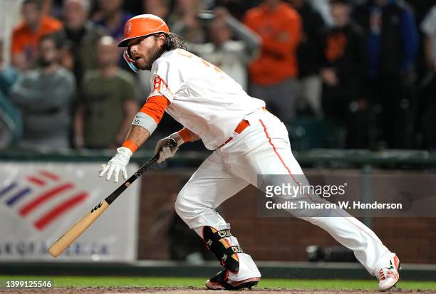 Brandon Crawford of the San Francisco Giants hits a walk-off RBI single scoring Darin Ruf to defeat the New York Mets 13-12 at Oracle Park on May 24,...