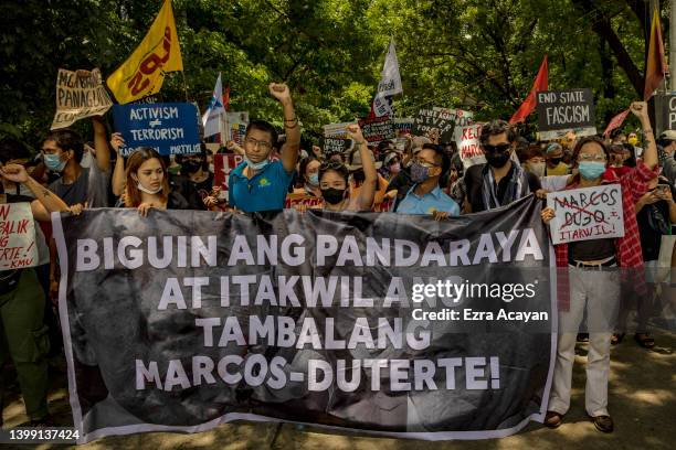 Anti-Marcos activists take part in a protest against election results at the Commission on Human Rights office on May 25, 2022 in Quezon city, Metro...