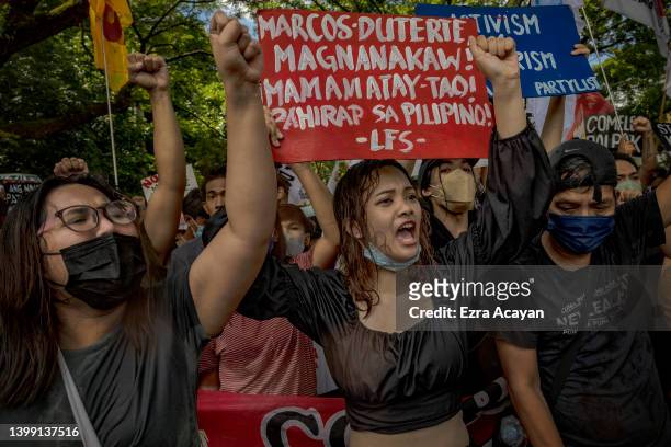 Anti-Marcos activists take part in a protest against election results at the Commission on Human Rights office on May 25, 2022 in Quezon city, Metro...