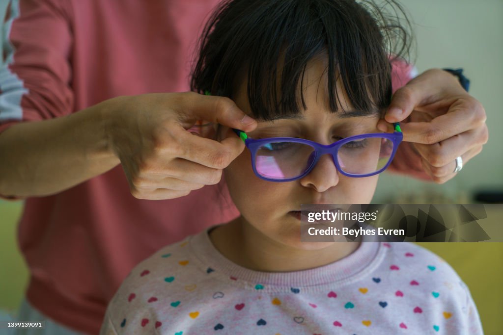Doctor giving the child new glasses