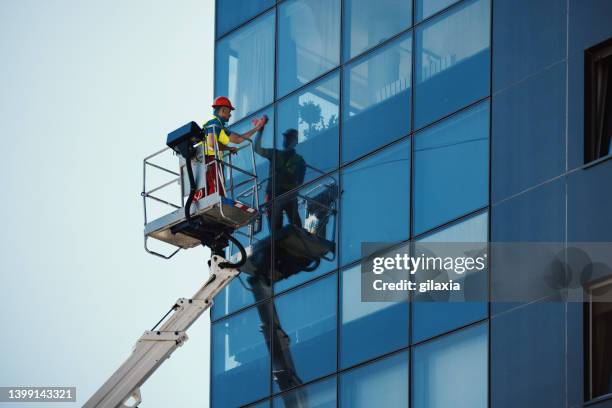 cleaning windows on a residential building. - fönsterputsare bildbanksfoton och bilder