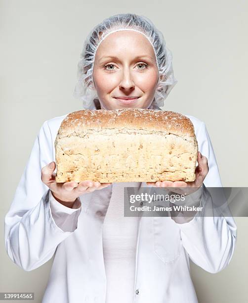 a delicious loaf of bread - baker smelling bread photos et images de collection