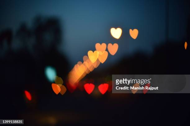 colourful heart shape bokeh. - bokeh love stock pictures, royalty-free photos & images