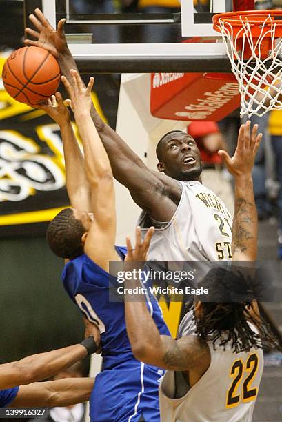 Wichita State's Ehimen Orukpe, right, blocks the shot of Drake's Jeremy Jeffers during the second half at Charles Koch Arena in Wichita, Kansas,...