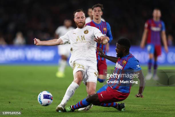 Rhyan Grant of the All Stars is challenged by Samuel Umtiti of FC Barcelona during the match between FC Barcelona and the A-League All Stars at Accor...