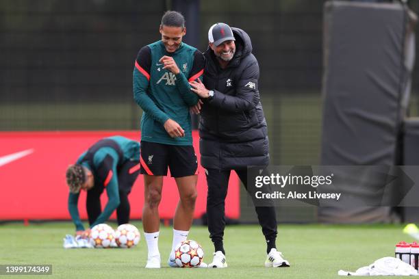 Virgil van Dijk of Liverpool and Juergen Klopp, Manager of Liverpool interact during a training session at AXA Training Centre on May 25, 2022 in...