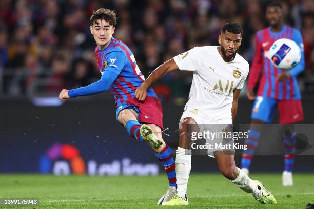 Gavi of FC Barcelona takes a shot on goal next to Adrian Mariappa of the All Stars during the match between FC Barcelona and the A-League All Stars...