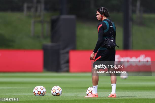 Trent Alexander-Arnold of Liverpool wears a device whilst taking free kicks during a training session at AXA Training Centre on May 25, 2022 in...