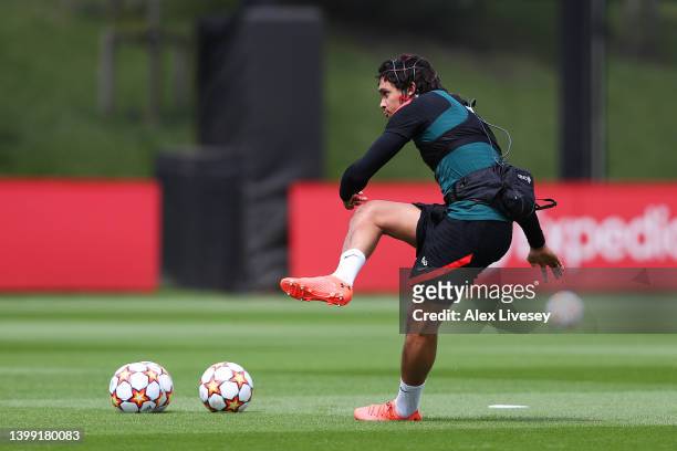 Trent Alexander-Arnold of Liverpool wears a device whilst taking free kicks during a training session at AXA Training Centre on May 25, 2022 in...