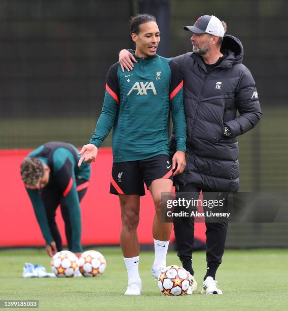 Virgil van Dijk of Liverpool and Juergen Klopp, Manager of Liverpool interact during a training session at AXA Training Centre on May 25, 2022 in...