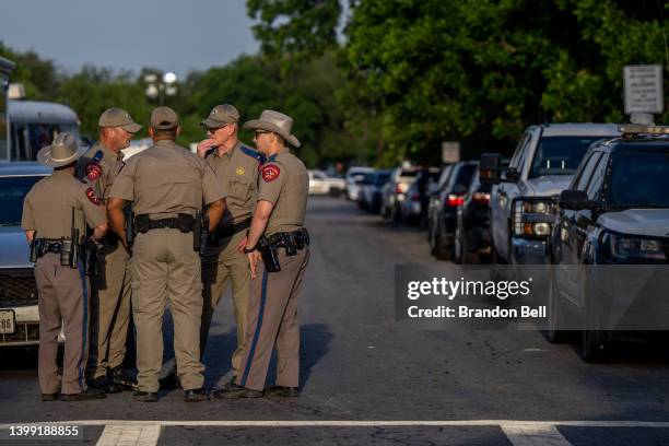 Law enforcement officers gather outside of Robb Elementary School following the mass shooting there on May 25, 2022 in Uvalde, Texas. According to...
