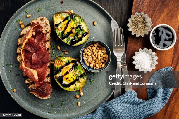 baked eggs with avocado and serrano ham - ketogenic diet stock pictures, royalty-free photos & images