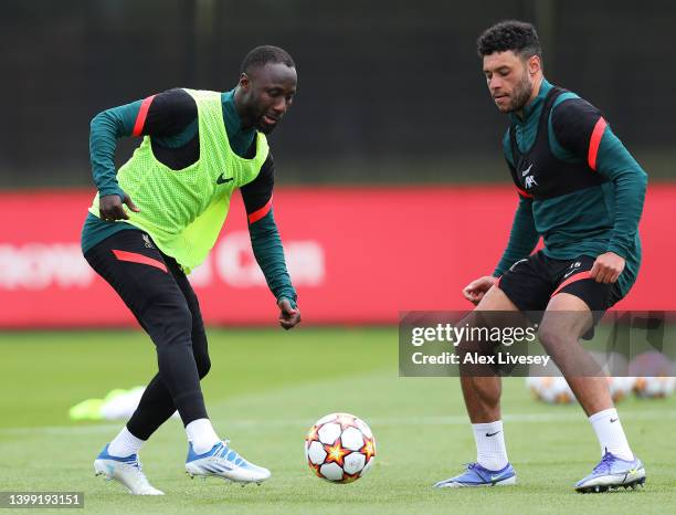 Naby Keita and Alex Oxlade-Chamberlain of Liverpool battle for the ball during a training session at AXA Training Centre on May 25, 2022 in Kirkby,...